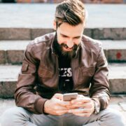 Young bearded man using smartphone